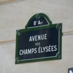a sign on the side of a building that says avenue des champs elysees