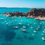 a group of boats floating on top of a body of water