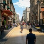 a group of people walking down a street next to tall buildings